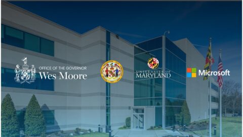 Exterior of a modern building with large glass windows and landscaped surroundings. Overlaid logos include the Office of the Governor (Wes Moore), the State of Maryland, the University of Maryland, and Microsoft—suggesting a collaborative initiative between government, academia, and technology sectors